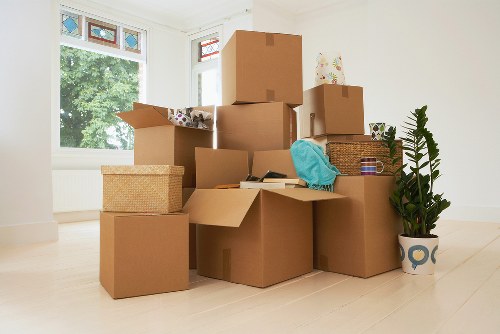 Employee assessing safe manual handling near stacked storage items